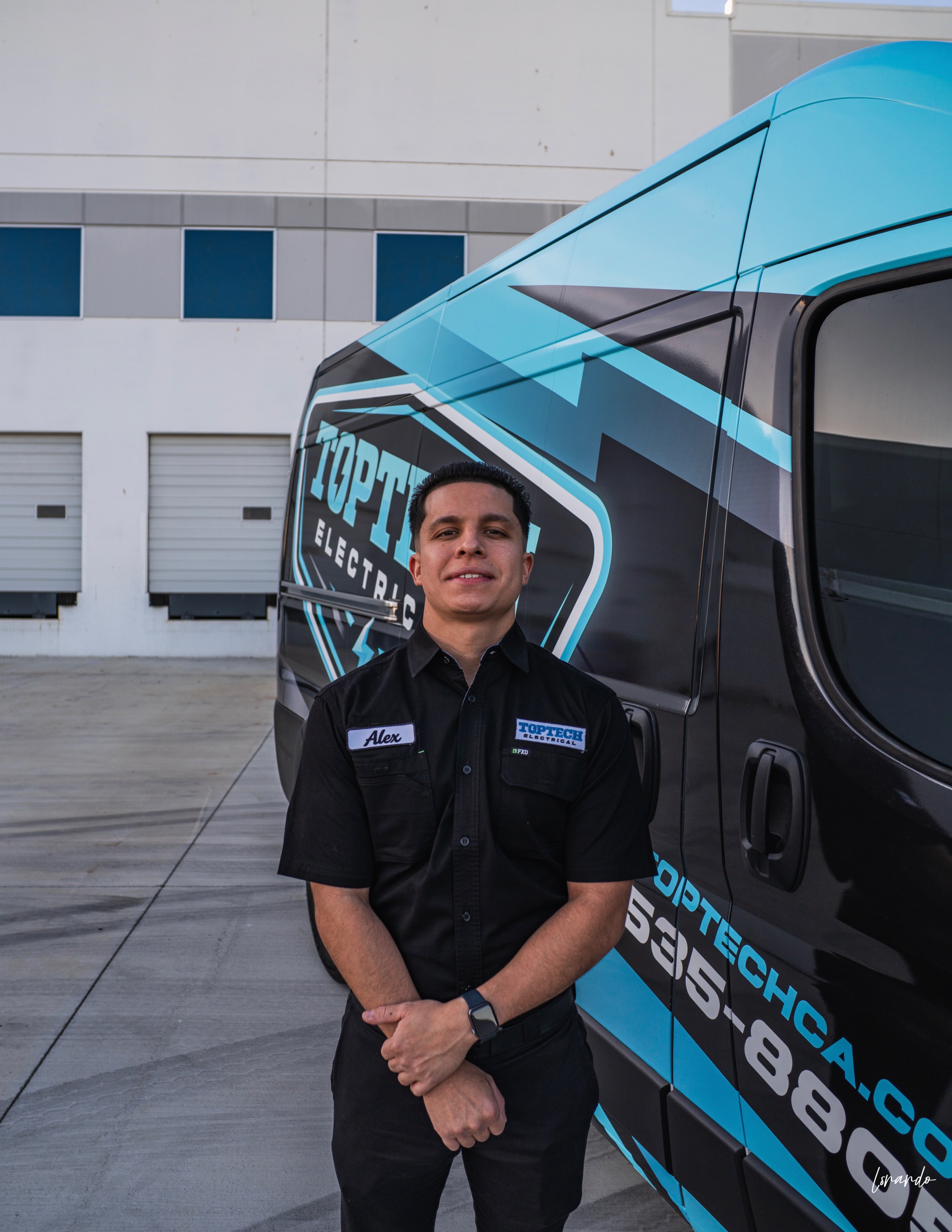 Alex Gonzalez owner of TopTech electrical Bay Area California In front of service vehicle